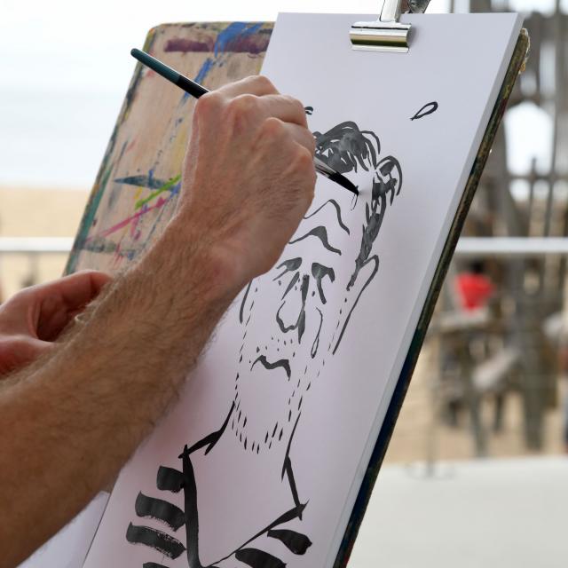 Artiste en train de dessiner près de la plage